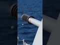 “Crisp long-lens footage in daylight. Foredeck close-up of an OTO Melara 76 mm automatic