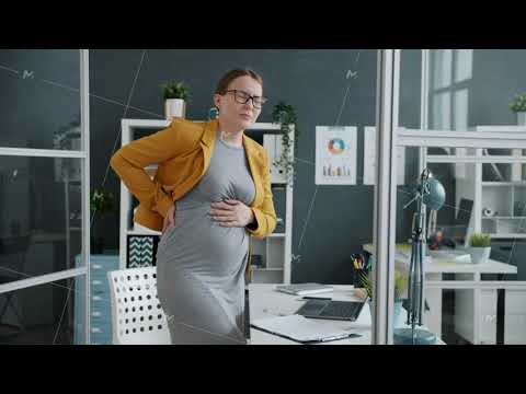 Pregnant businesswoman feeling stomach ache touching belly in workplace
