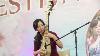 Pretty Chinese Girl Plays Music on Traditional 