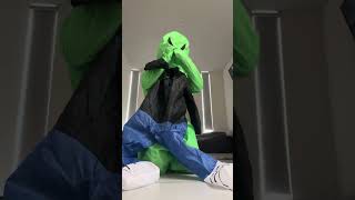 Putting on a full body alien inflatable costume with a morphsuit under