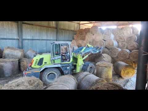 Stacking hay with a loader, Bolivar Equestrian Club