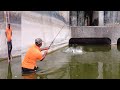 Professional Fisherman makes steps into the water power plant and does fishing