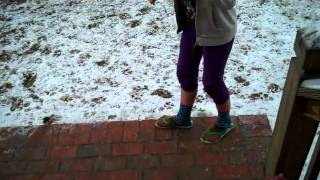 In the snow wearing shorts, toe socks, and flip flops!