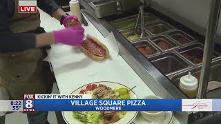 Kenny's eyeing up the menu at Village Square Pizza
