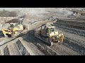 Aerial View Of Four Caterpillar D9T &amp; Komatsu D275AX Bulldozers Team -Levelling Huge Mining Site