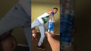 Guy attempts water bottle cap challenge but accidentally kicks little boy