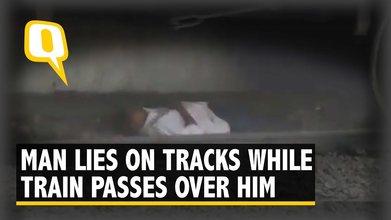 Caught on Camera: Man Lies on Tracks as Train Passes over Him - YouTube