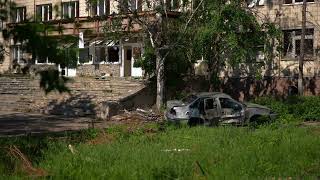 Adult Swim Bump: Panning Shot of a Destroyed Car with Bullet Holes at a Ruined Building (FANMADE)