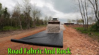 Installing Geotextile Fabric And Rock On The Track
