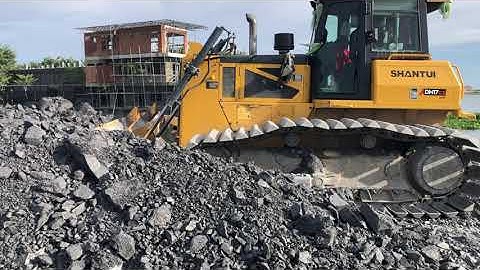 The SHANTUI DH17c2 Bulldozer Machine Push Rock For Backfill Uploading Dump Truck On Construction.