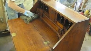 Tom Johnson of Thomas Johnson Antique Furniture Restoration in Gorham, Maine restores the finish to a desk that had acquired 