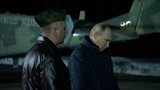 Putin inspects helicopters and missiles in visit to military base