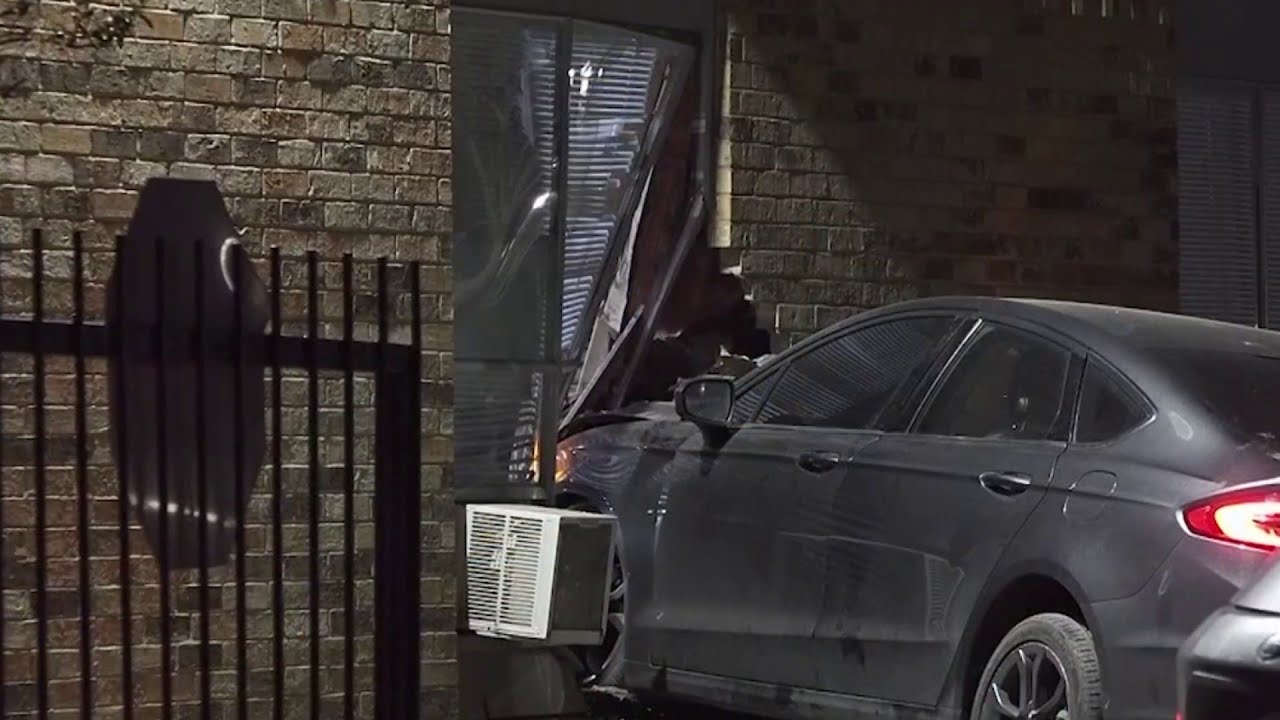 Car loses control while entering complex, crashes into apartment - YouTube