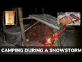 Solo overnight improving the poachers camp during a snowstorm and cooking meat on a rock