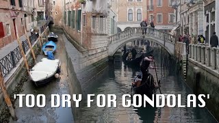 'Almost-empty canal' Low tide leaves Venice canals almost dry