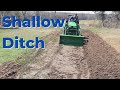 Using a Tiller and FEL to Dig a Drainage Ditch - John Deere 2025R