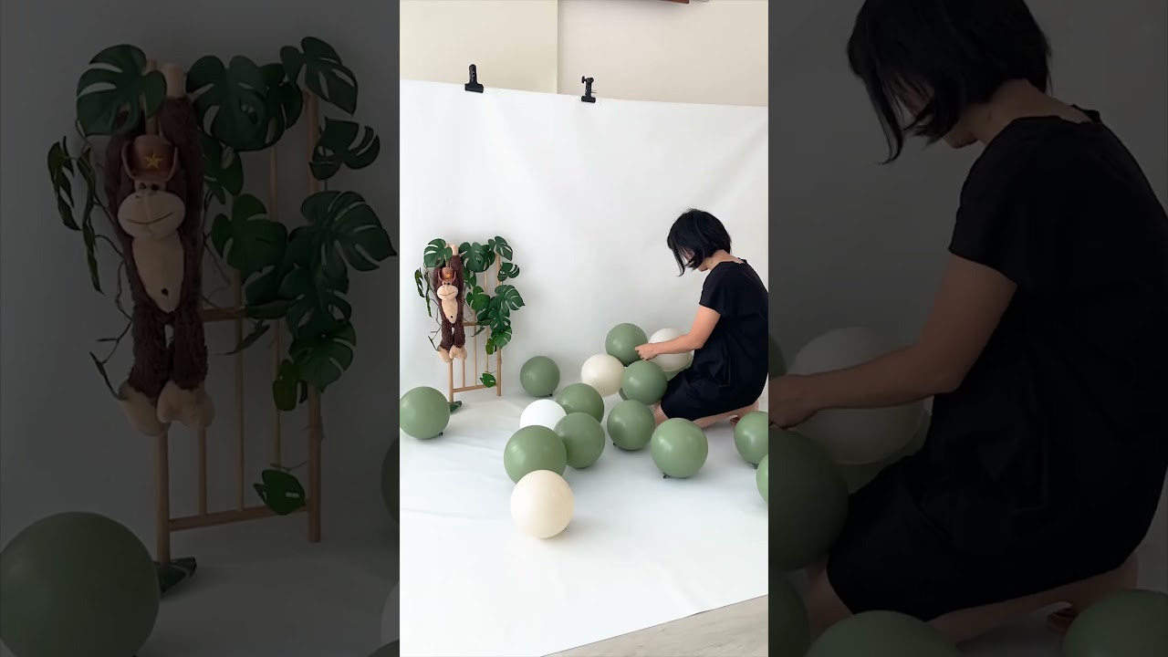 Jungle theme green balloon garland cake smash setup