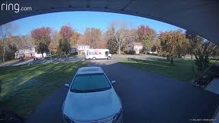 FedEx = Worst Courier. Delivery Driver drops package out of truck and slides to garage door.