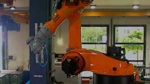KUKA robot KR 16 operate at a plastics injection molding machine