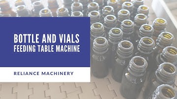 Glass amber Bottle feeding table - flow conveyor - indexing conveyor belt for vials | RELIANCE