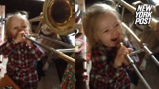 This baby trombone player blows