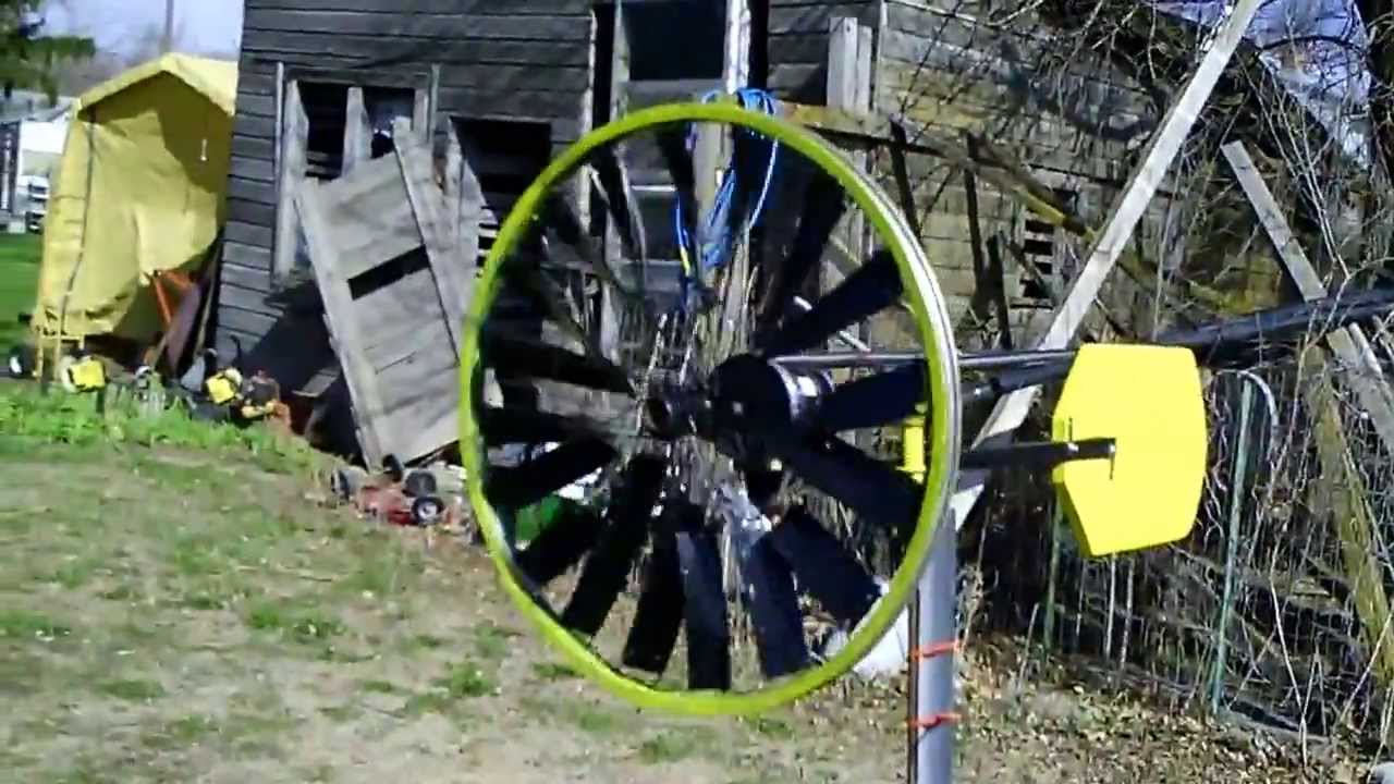 Simple home made wind turbine from bike wheel in the wind - YouTube