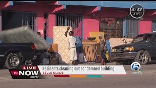 Residents cleaning out condemned building in Belle Glade
