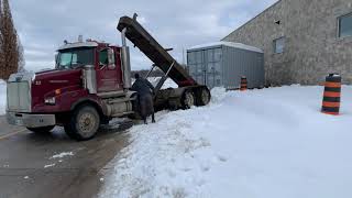 Storage container pickup with a roll off truck.