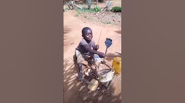 Thumbnail of Little boy plays his homemade drum set.