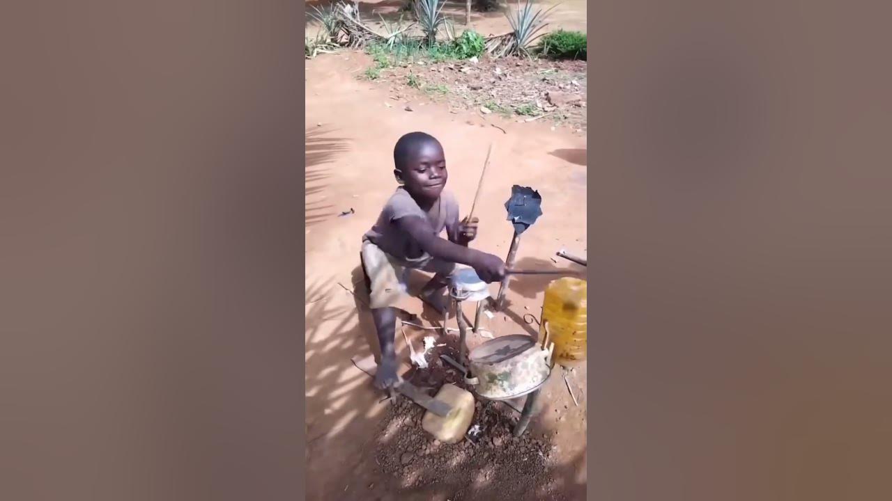 Little boy plays his homemade drum set.