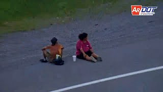 Arkansas: Two Pedestrians Sitting On Shoulder Of Interstate