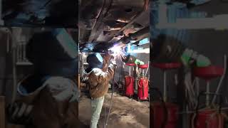 Professional welder welding exhaust