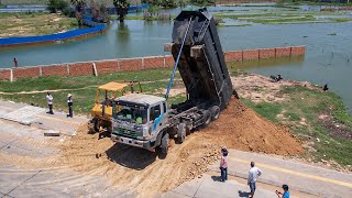 Huge Pond Land Filling Up By Bulldozer Pushing Soil Into Water With 12Wheel Dump Truck Moving Dirt