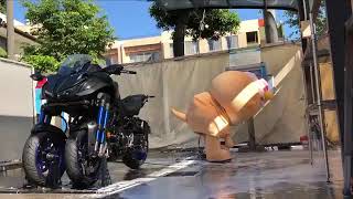 Chiitan washes a motorcycle