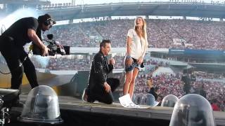 Robbie Williams and a girl on stage