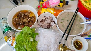 Delicious dinner with rice porridge,boiled pig's innards,grilled pork, vermicelli,beer,chicken feet