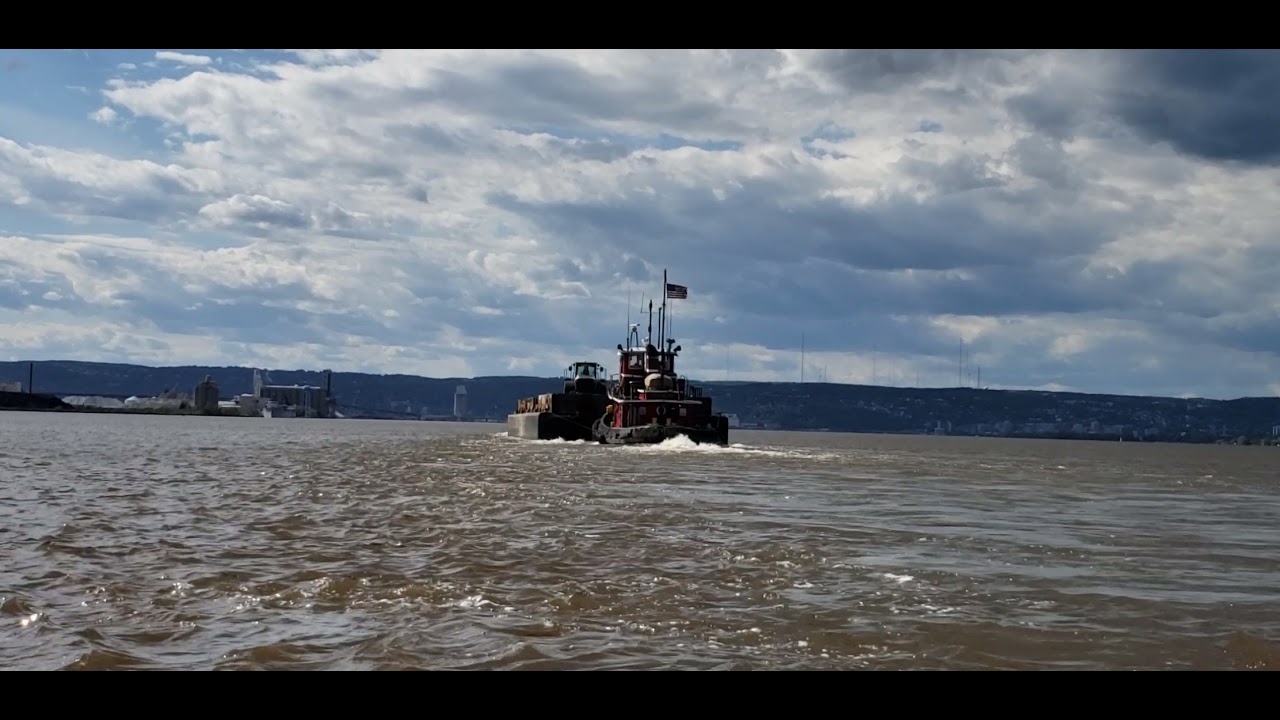 Tugboat John R Asher pushing a barge across Superior Bay