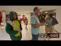 Climate activists dressed as dinosaurs demonstrate in DC train system and shopping center