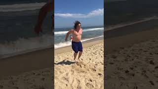 Kid attempts backflip on the beach