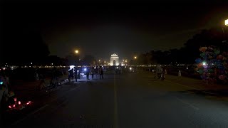 Timelapse of people walking on Rajpath in front of India Gate at night