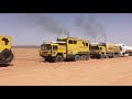 Heavy recovery 30 ton gasoline truck in  the sahara desert with three man kats