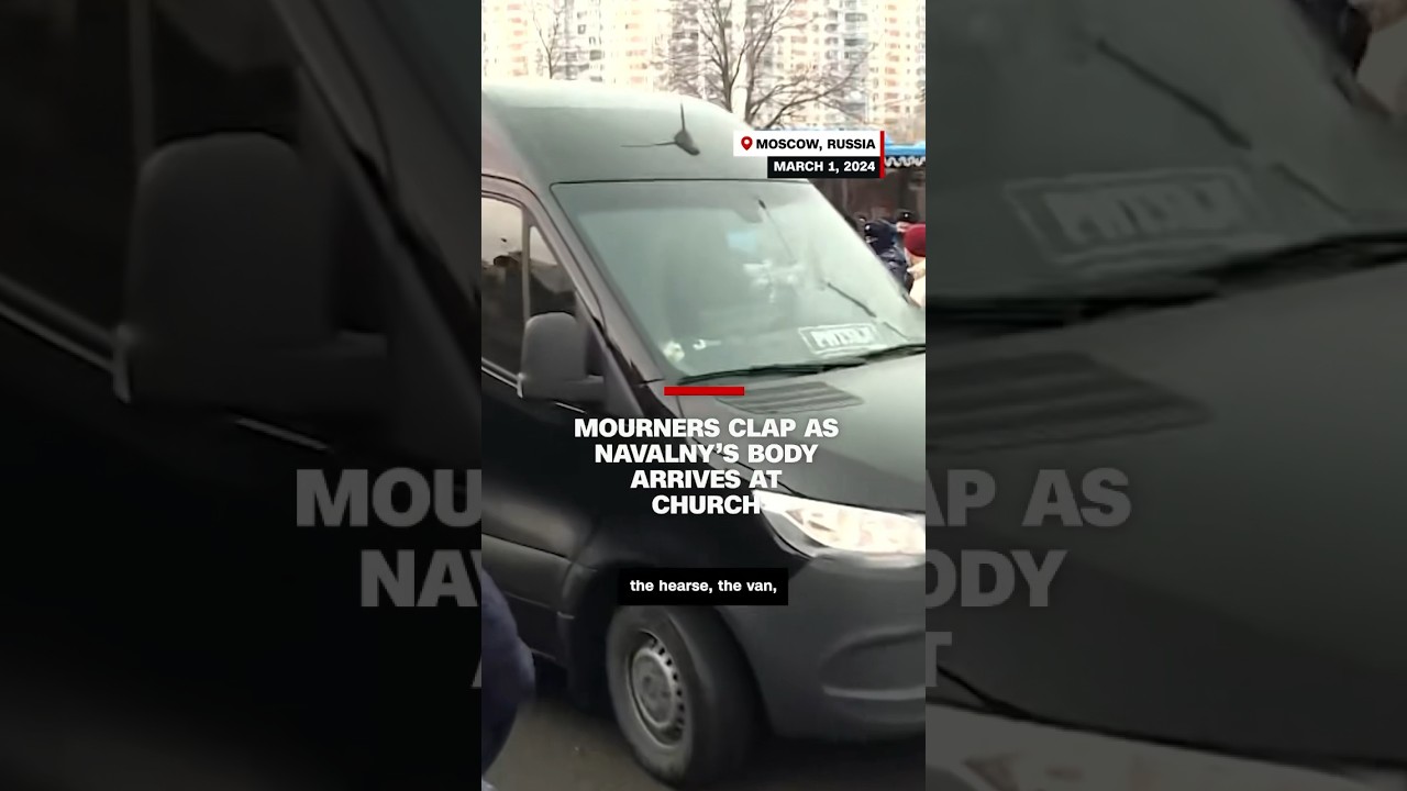 Mourners applaud as Navalny's body arrives at the church