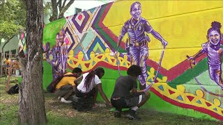 Teens, Miami police work together to paint mural honoring victims of gun violence