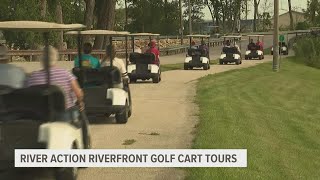 Seniors golf cart down the Illinois-side riverfront in River Action's annual guided tour