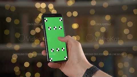 Closeup view of smartphone with tracking points on screen in man hands against bokeh background