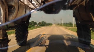 Motorcycle Drives Under Tractor