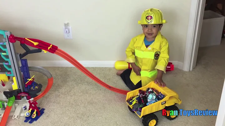 Ryan plays with HOT WHEELS ULTIMATE GARAGE playset with Disney Cars