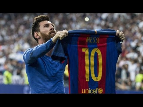messi holding up jersey