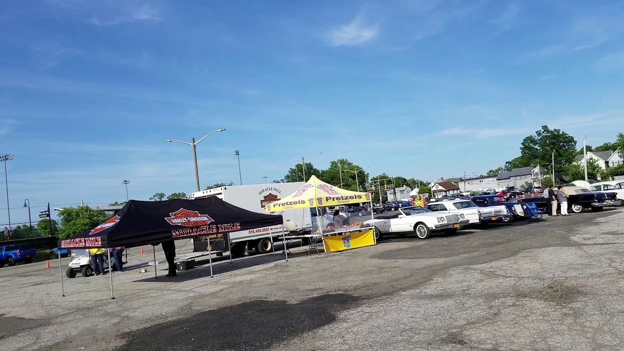 SCENE AT CAR SHOW IN TRAIN STATION PARKING LOT OYSTER BAY, NEW YORK