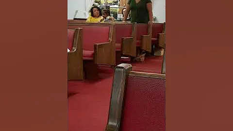 Sister Gloria Mosley giving her testimony of God's...